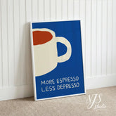 White framed blue retro coffee poster leaning against a white wainscoting wall on carpet.