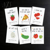 Flat lay of six funny food pun Valentine cards from NJS studio, featuring cute illustrations.