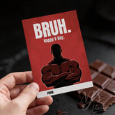 Hand holding a funny Valentine card with 'BRUH. Happy V-Day.' and muscular cartoon, NJS studio