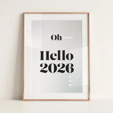 Minimalist New Year print with 'Oh Hello 2026' in bold black text, rose gold frame, NJS studio style