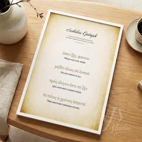 White framed historical print lying on a wooden desk next to a white vase, academic decor.