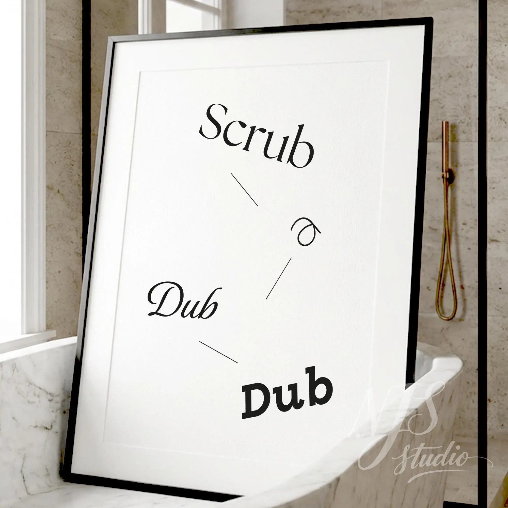 Minimal bathroom wall art featuring the phrase “Scrub a Dub Dub,” displayed in a black frame leaning on a marble bathroom counter.