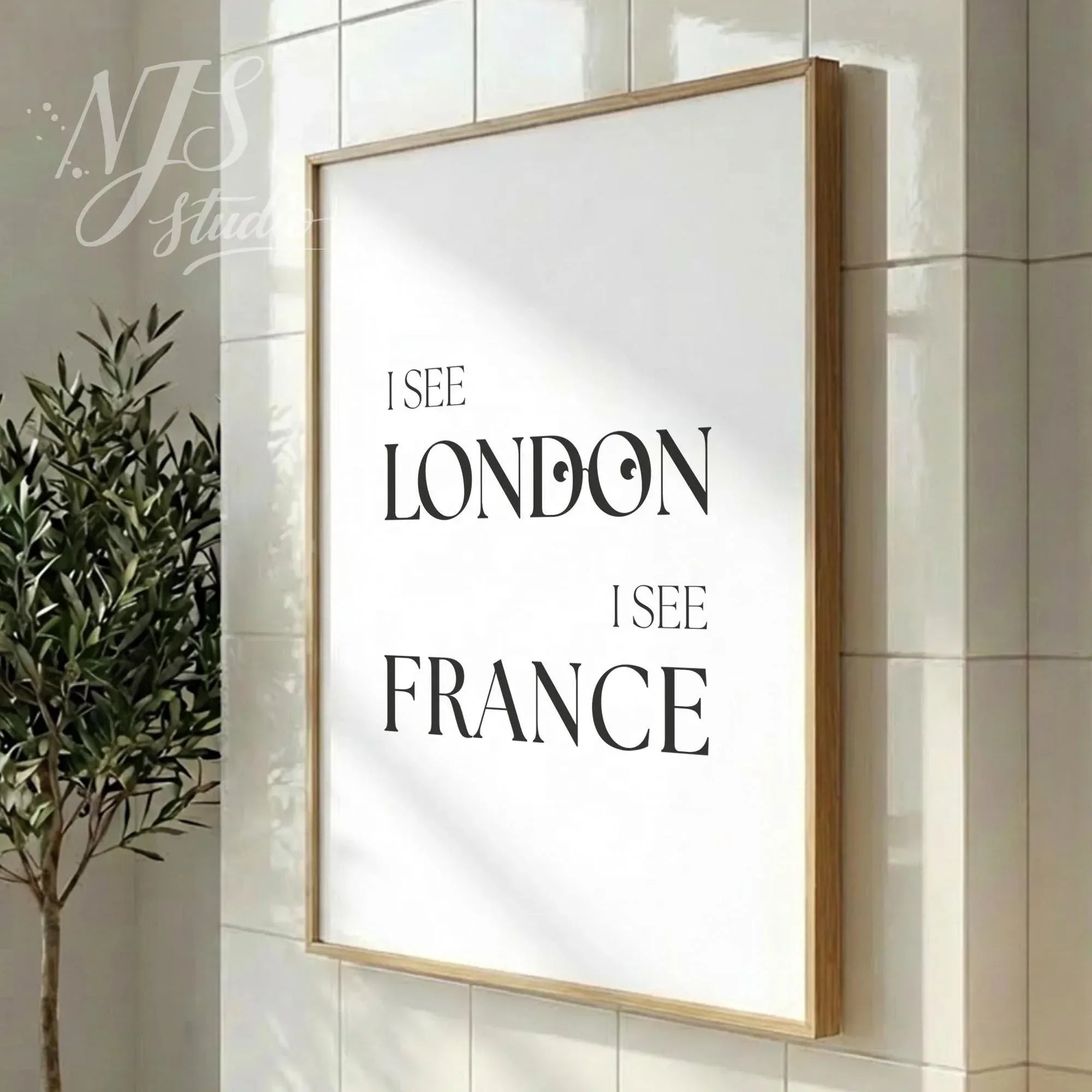 Modern bathroom poster featuring “I See London I See France,” styled in a vertical wood frame in a clean contemporary bathroom interior.