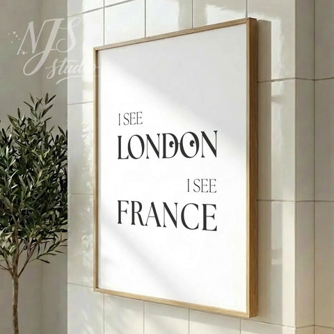Modern bathroom poster featuring “I See London I See France,” styled in a vertical wood frame in a clean contemporary bathroom interior.