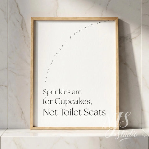 Bathroom quote wall art in a natural wood frame leaning on a marble shelf, adding subtle humor to a clean bathroom setting.