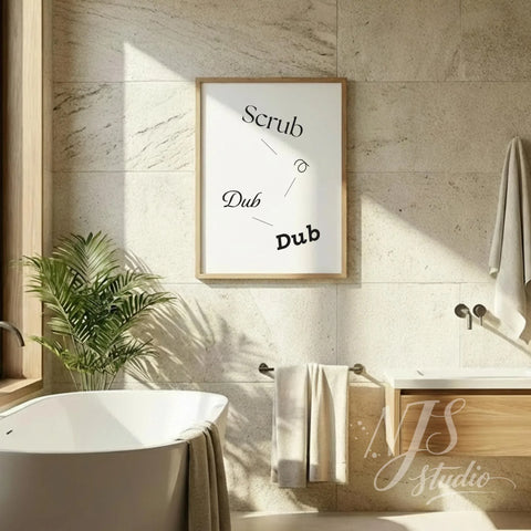 Funny bathroom quote wall art reading “Scrub a Dub Dub,” hung above a freestanding bathtub in a bright spa-style bathroom.