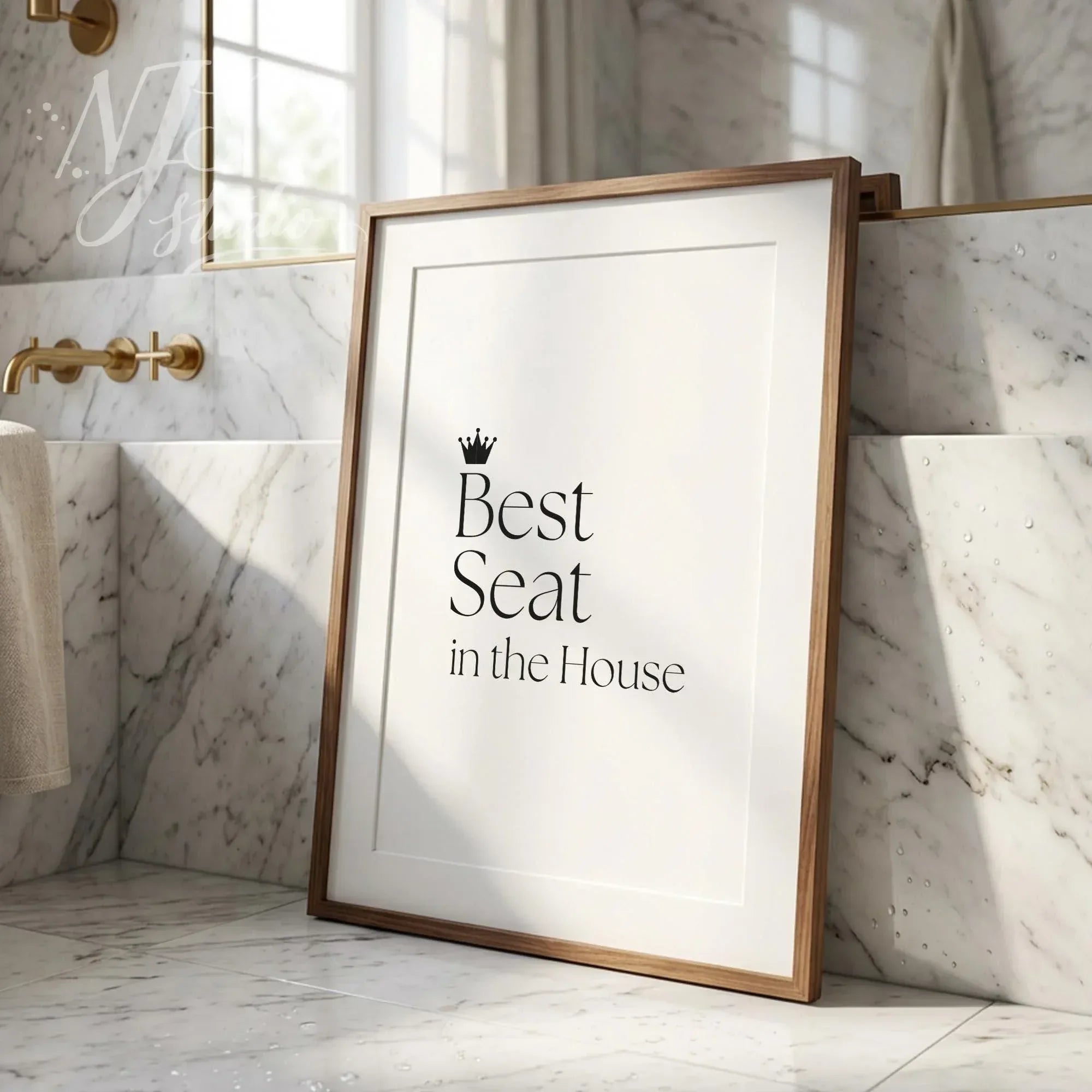 Humorous bathroom wall print saying “Best Seat in the House,” modern framed typography art styled in a bright marble bathroom interior.