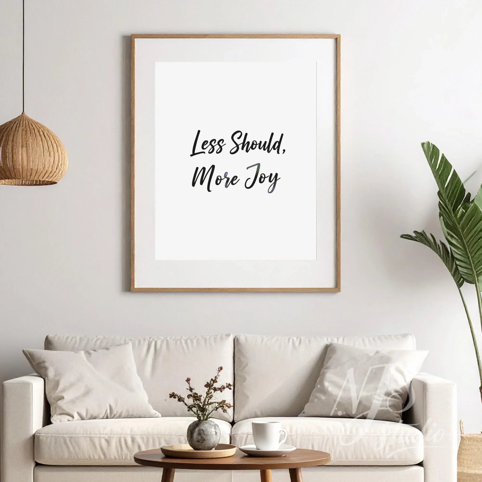 Large framed inspirational quote hanging above a sofa in a bright living room with boho decor.