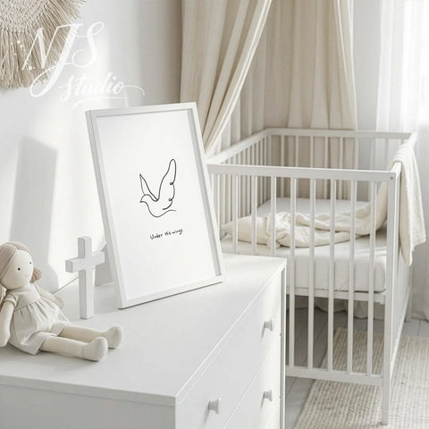 White framed cute bible print with a dove illustration standing on a dresser in a white nursery room.