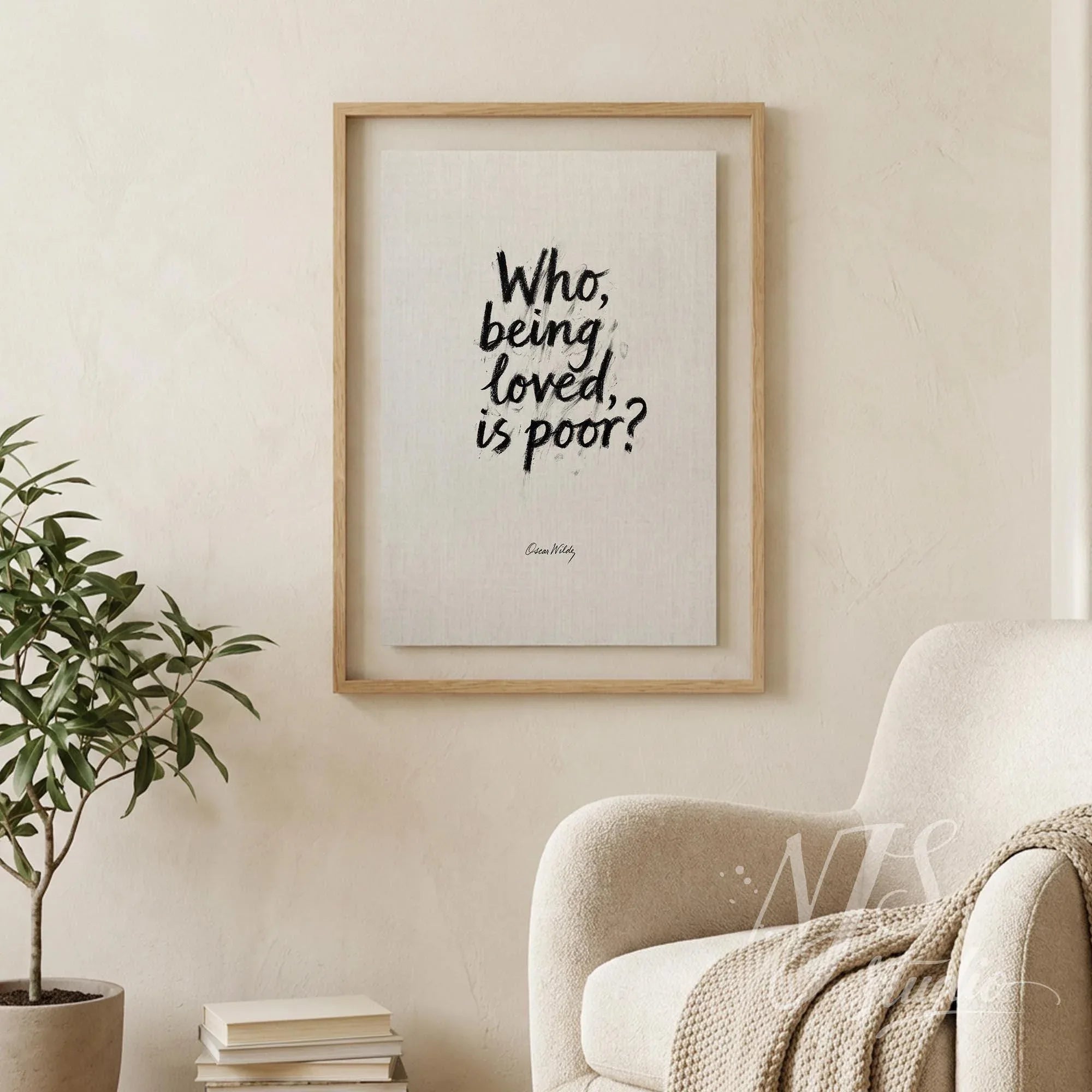 Framed literary quote print hanging on a beige wall next to a comfortable armchair, cozy decor.