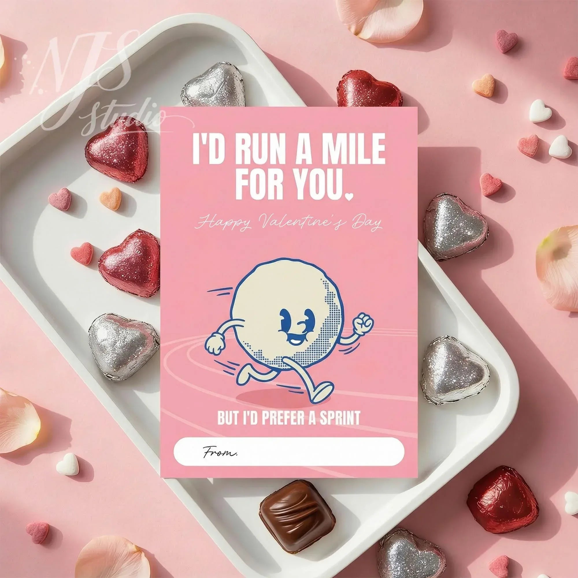 Funny Valentine's Day card with sprinting cartoon, candy hearts, and NJS studio branding flatlay