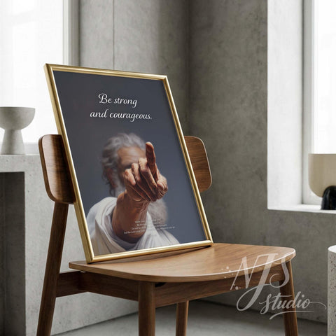 Gold framed bible verse print on chair. Dramatic Christian art Joshua 1:9 "Be strong and courageous" masculine decor.