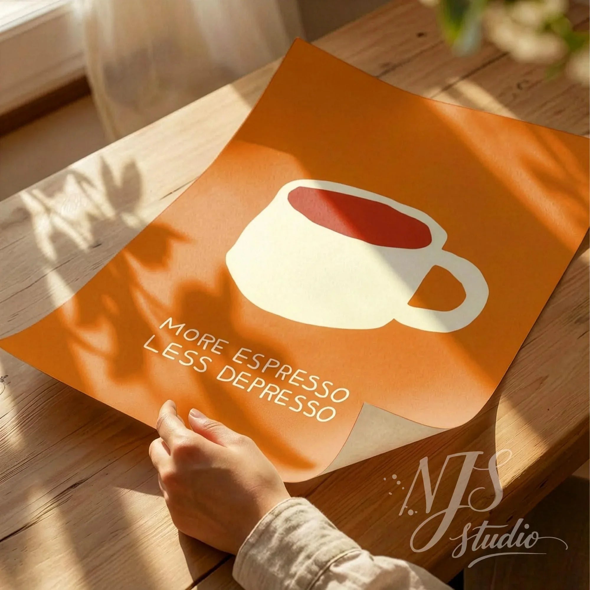 Hands unrolling a high quality orange art print with funny coffee quote for kitchen decor.