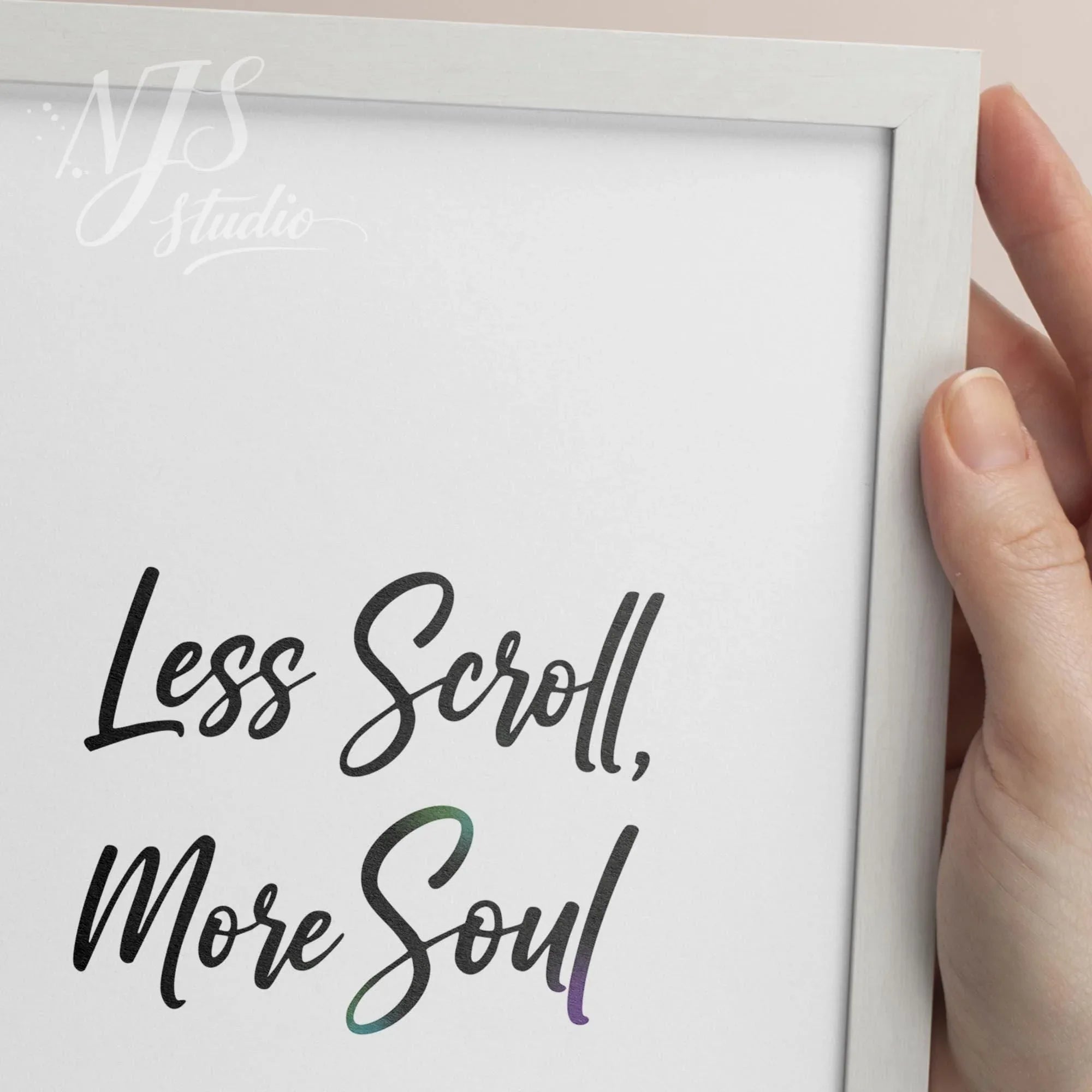 Hand holding a white framed print showing the artistic hand lettering detail of the word Soul.