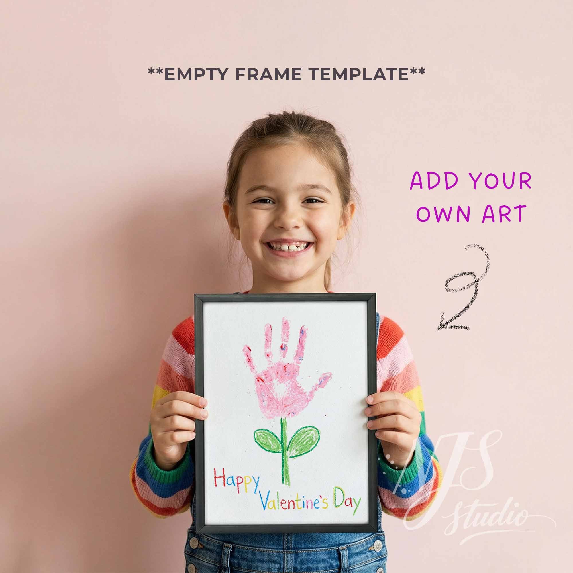 Child holding a frame with a handprint art for Valentine's Day against a pink background