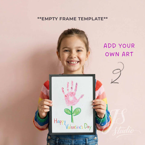 Child holding a frame with a handprint art for Valentine's Day against a pink background