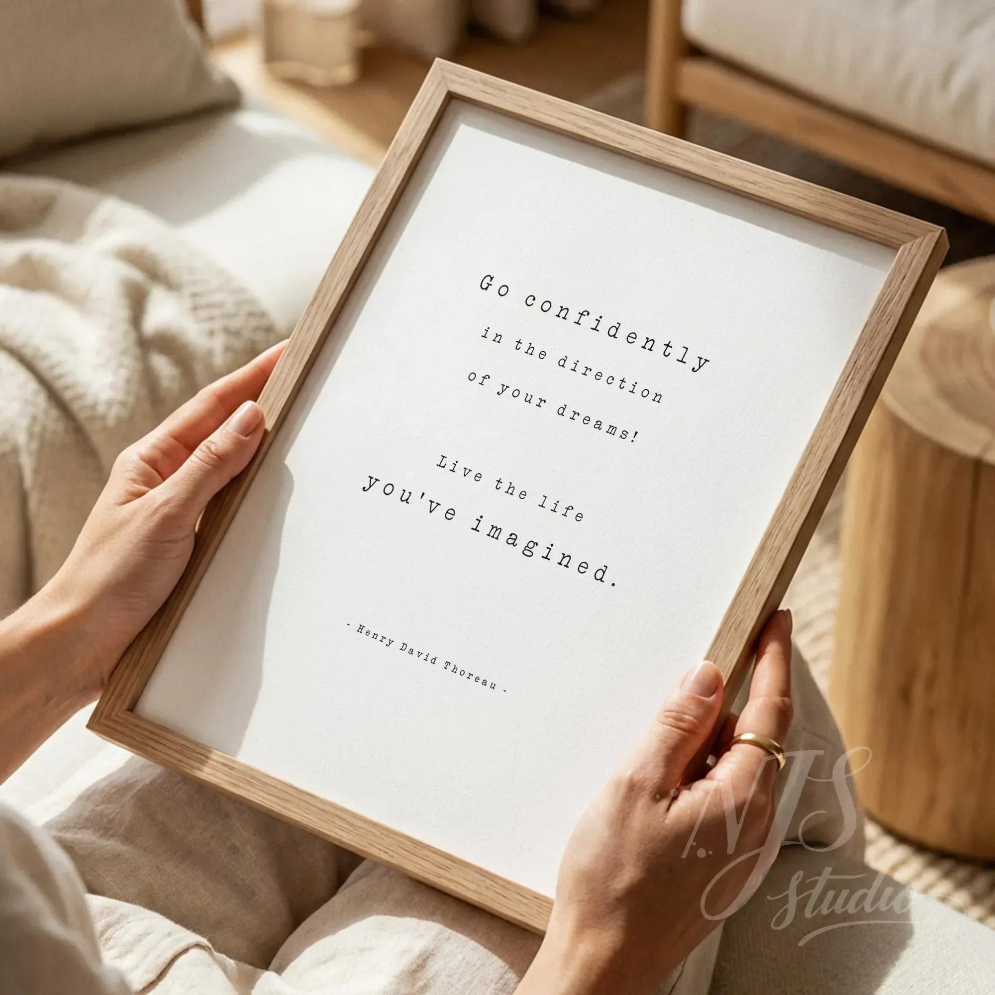 Close up of hands holding a wood framed print reading Live the life you've imagined, perfect graduation gift.
