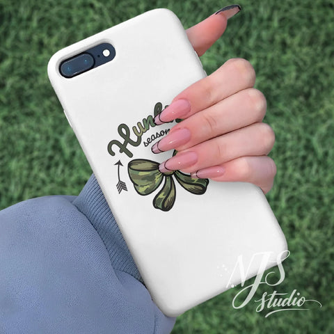Phone case decorated with a green camouflage bow and “Hunting Season” design, shown as a stylish fall accessory.