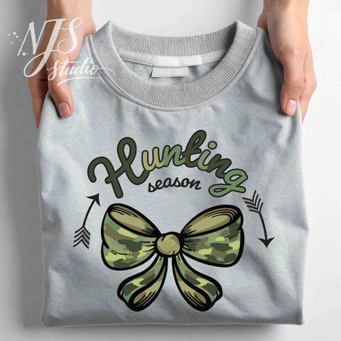Folded gray sweatshirt displaying a green camouflage bow with “Hunting Season” text, shown as a product detail mockup.