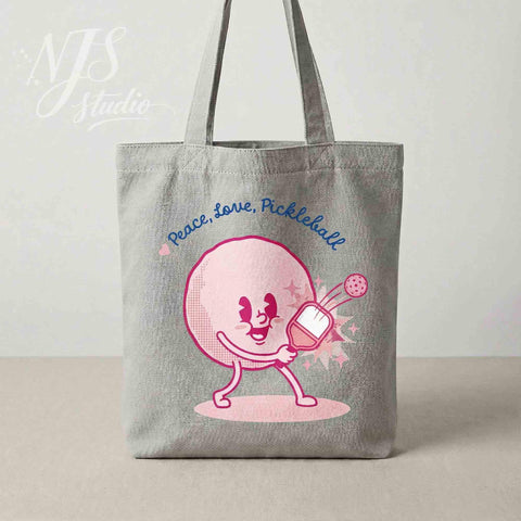 Canvas tote bag with cute pink pickleball character. "Peace Love Pickleball" SVG design for crafters and DIY gifts.