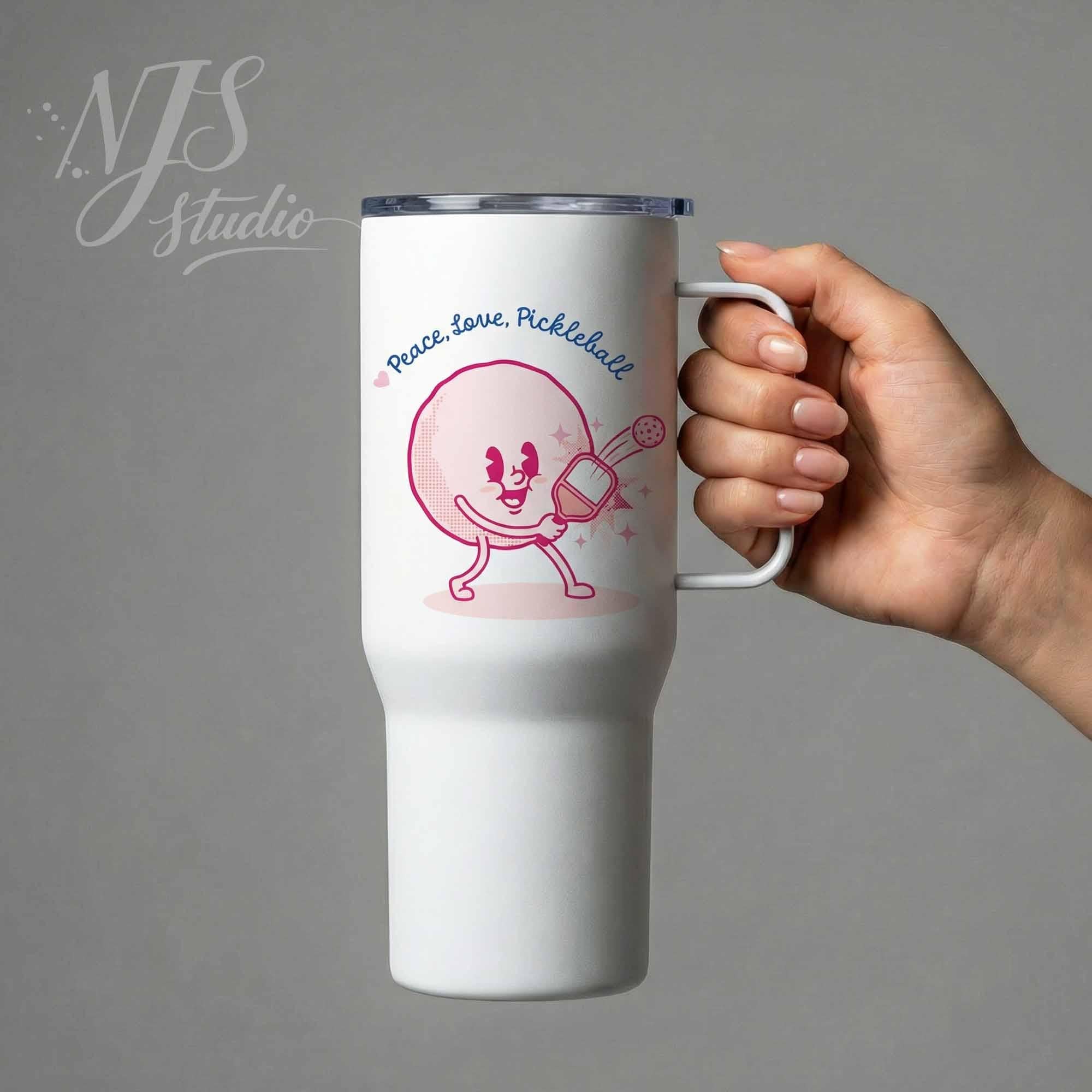 Hand holding white travel tumbler cup showcasing pink pickleball character design, suitable for DIY sublimation printing projects.