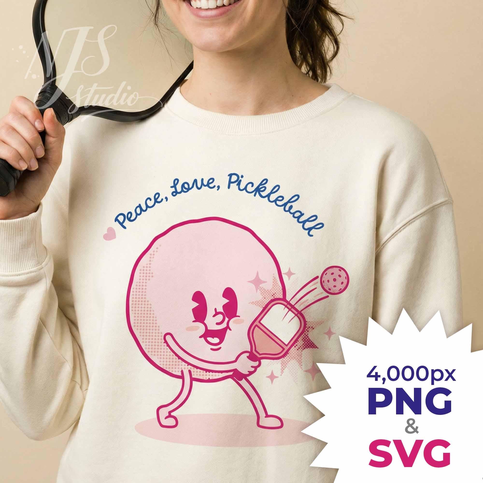 Smiling woman holding paddle wearing sweatshirt with retro Peace Love Pickleball design, listing includes 4000px PNG and Cricut SVG cut file.