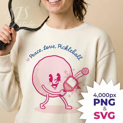 Smiling woman holding paddle wearing sweatshirt with retro Peace Love Pickleball design, listing includes 4000px PNG and Cricut SVG cut file.