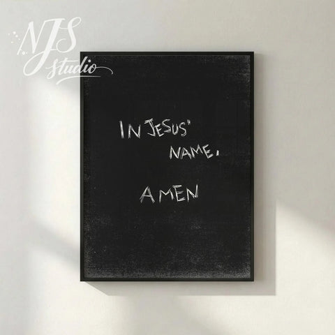 Black textured poster with handwritten “In Jesus’ Name, Amen” displayed in simple frame on neutral wall, modern Christian faith decor.
