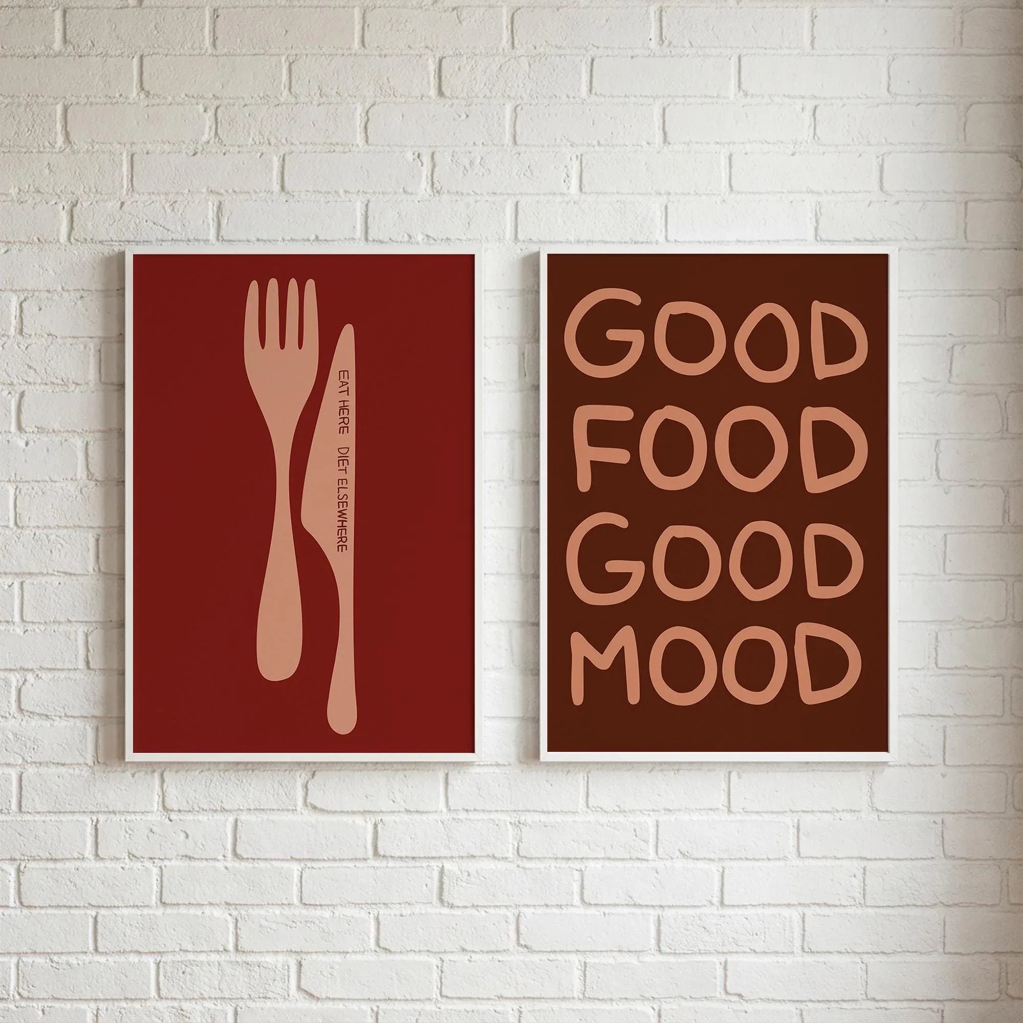 Dining room wall decor set featuring two brown and red prints: Eat Here Diet Elsewhere and Good Food Good Mood on a white brick wall.