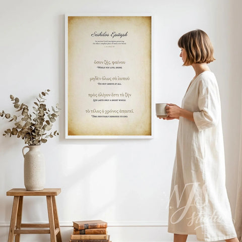 Woman holding coffee admiring a large framed vintage-style Seikilos Epitaph print on a white wall.