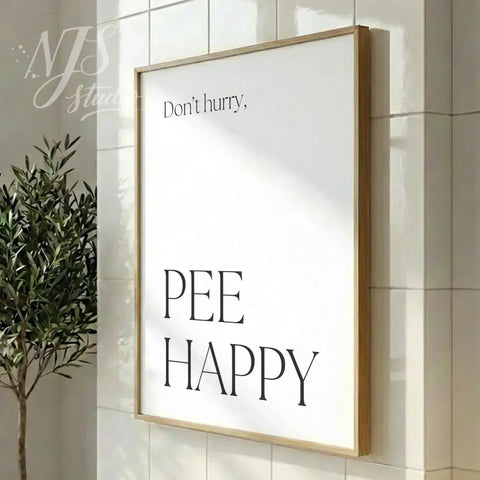 Modern bathroom poster featuring the phrase “Don’t hurry, Pee Happy,” displayed in a vertical wood frame in a clean interior.