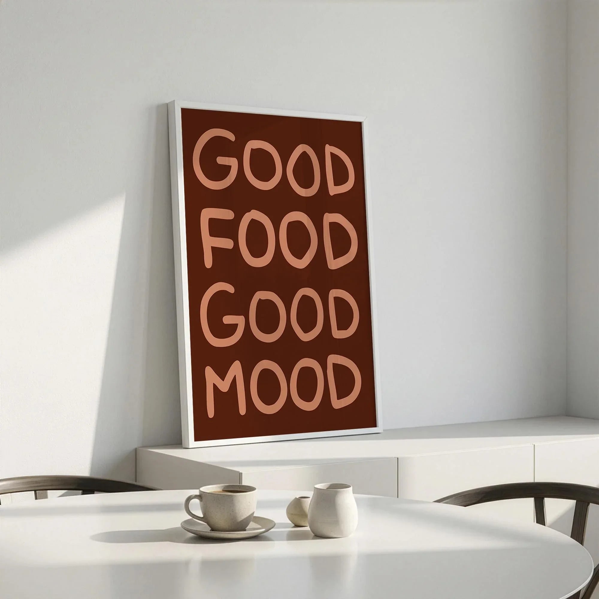Close up of a modern brown kitchen art print with bold hand drawn text Good Food Good Mood.