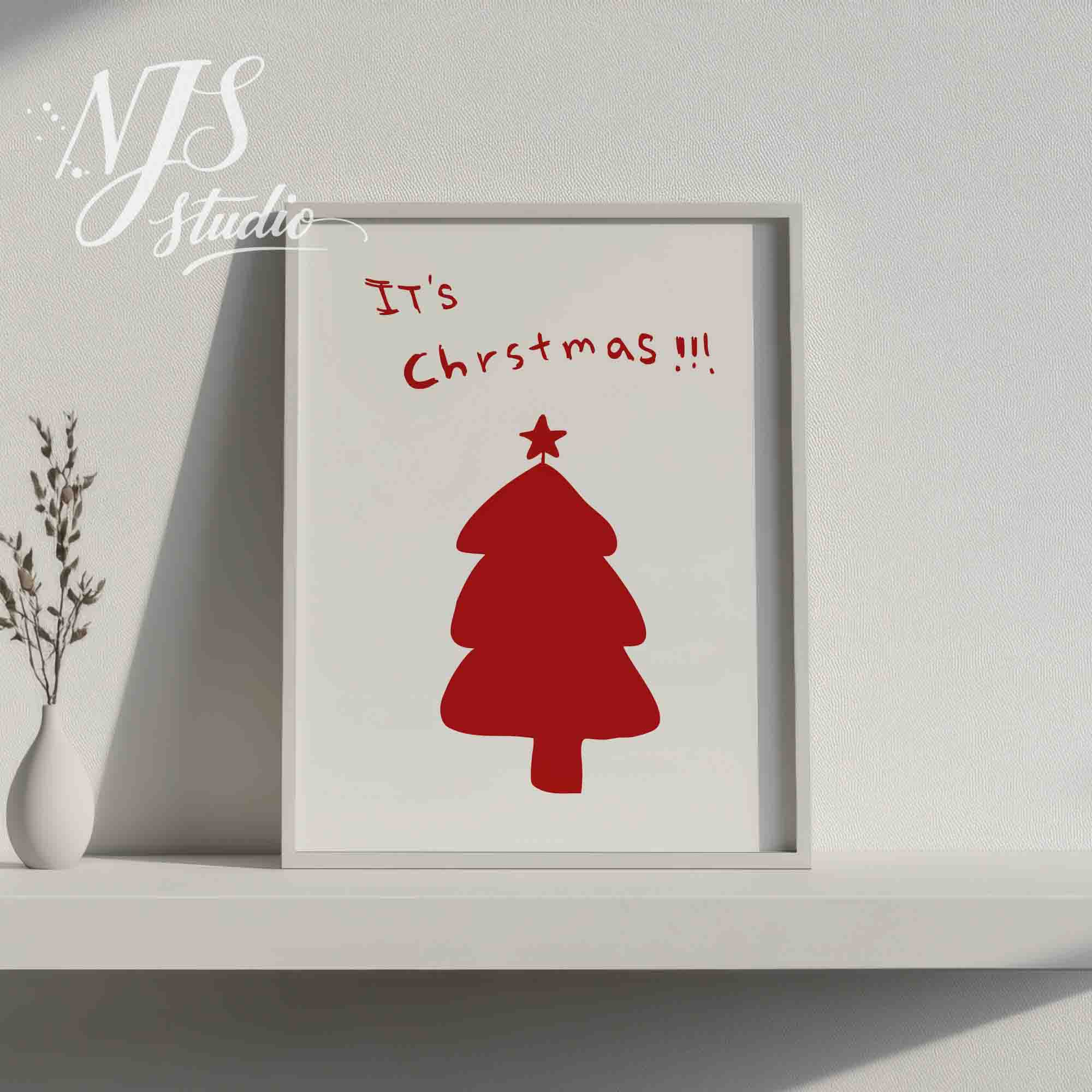 White framed minimalist Christmas poster on a shelf with a modern white vase and dried flowers.