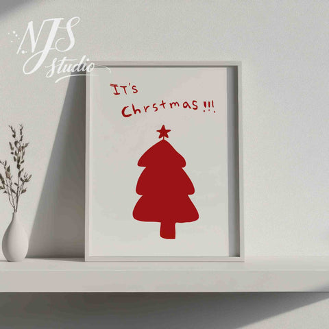 White framed minimalist Christmas poster on a shelf with a modern white vase and dried flowers.