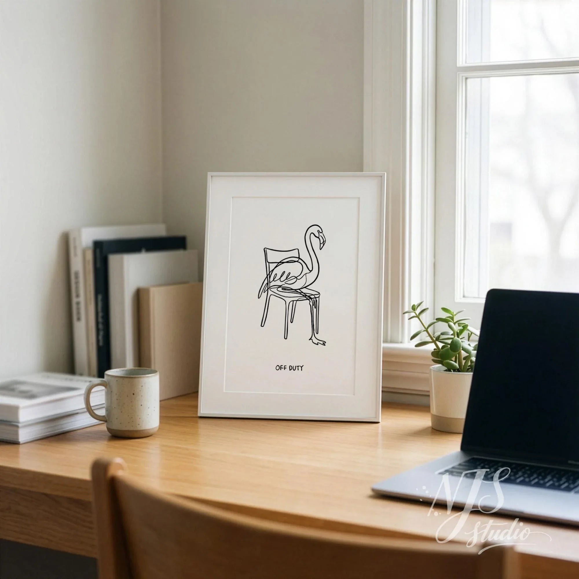 Flamingo line drawing poster with Off Duty quote displayed on desk near window, minimalist home office wall art print in neutral Scandinavian interior