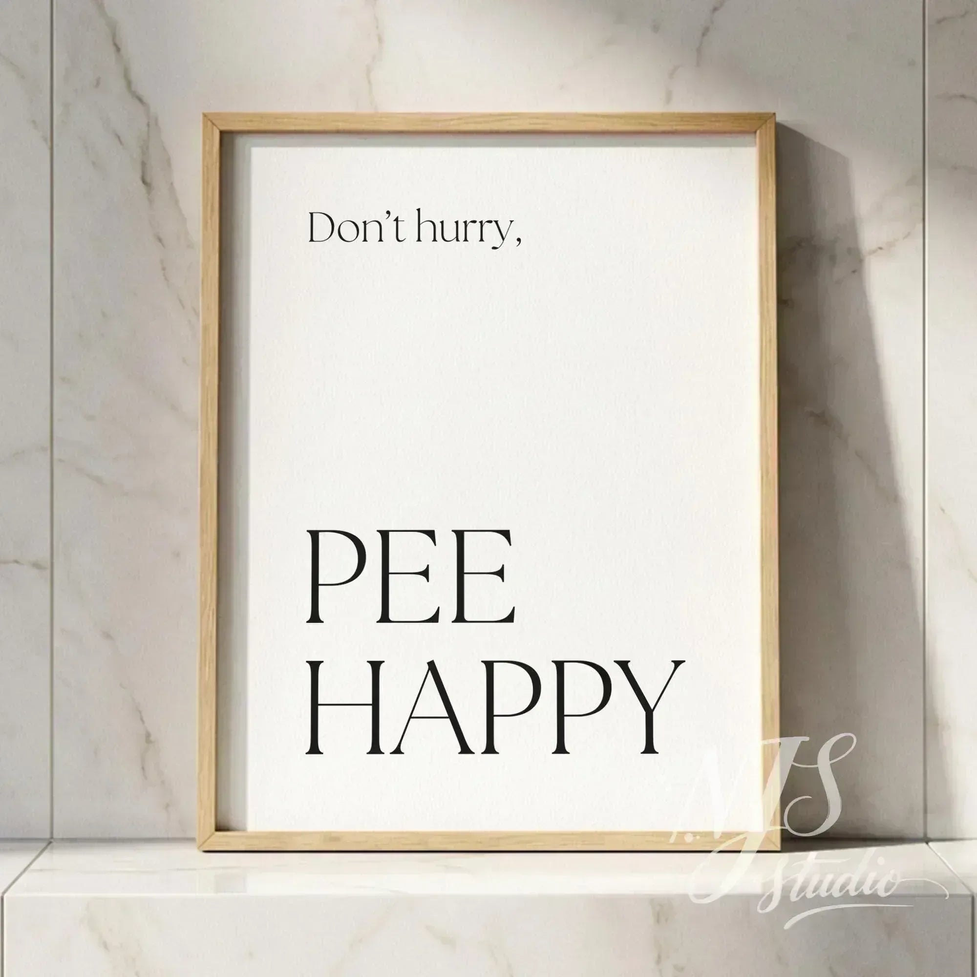 Minimal typography bathroom poster with the text “Don’t hurry, Pee Happy,” framed in natural wood against a marble tile wall.