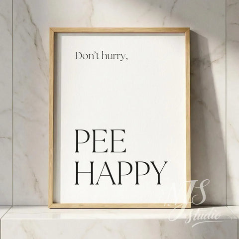 Minimal typography bathroom poster with the text “Don’t hurry, Pee Happy,” framed in natural wood against a marble tile wall.