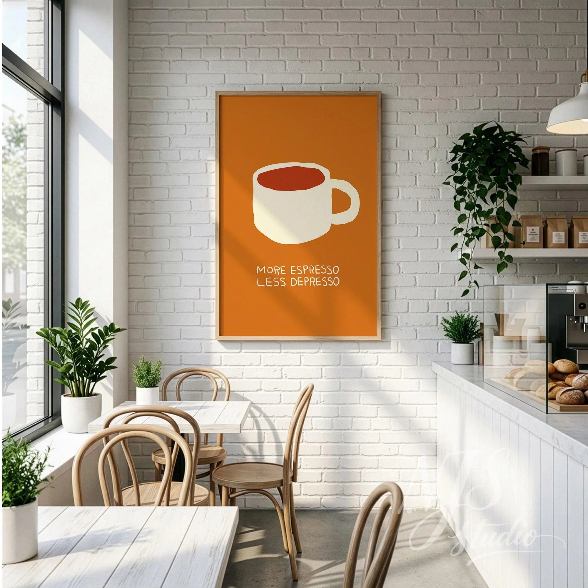 Large framed coffee wall art hanging on a white brick wall in a bakery or cafe.