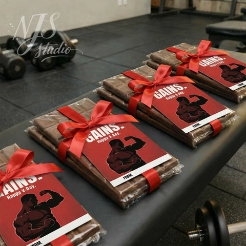 Gym-themed chocolate gift bars with red bows on a bench, perfect workout partner gift from NJS studio